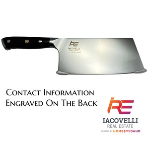May include: A large, stainless steel cleaver with a black handle. The blade has a rectangular shape and features the logo "IACOVELLI REAL ESTATE" and the text "HOMES OF IDAHO".