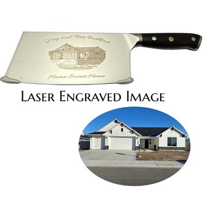 May include: A stainless steel cleaver with a black handle. The blade is laser engraved with a house illustration, the text "Greg and Terri Burkhart", and "Home Sweet Home". The image also includes a photo of a house and the text "LASER ENGRAVED IMAGE".