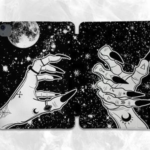 May include: Black and white illustration of two hands reaching out against a starry night sky background. One hand has long, sharp nails and the other has a crescent moon and other symbols on the wrist.