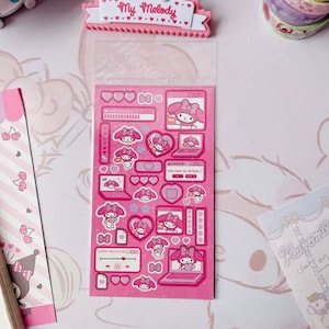 May include: A sheet of pink and white stickers featuring My Melody, a popular Japanese character. The stickers feature My Melody in various poses, including on a computer, holding a heart, and wearing a bow. The stickers are perfect for adding a touch of cuteness to your planner, journal, or laptop.