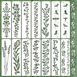 May include: A collection of 14 white stencils with various botanical and fantasy designs. The stencils feature floral patterns, vines, leaves, and flying bat silhouettes. The stencils are arranged on a green wooden surface.