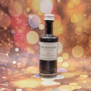 May include: A miniature bottle of The Botanist Islay Dry Gin with a black and silver label. The label has the text 