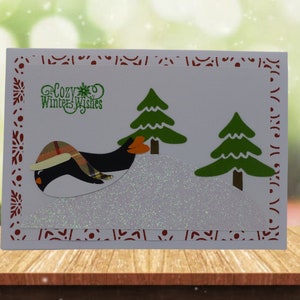 Tarjeta de invierno de pingüino deslizante