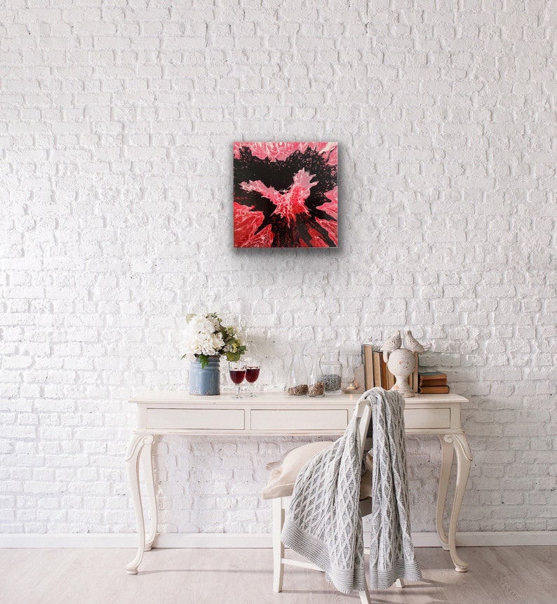 May include: Abstract painting with black and pink colors. The painting has a splatter effect and is framed in a white frame.