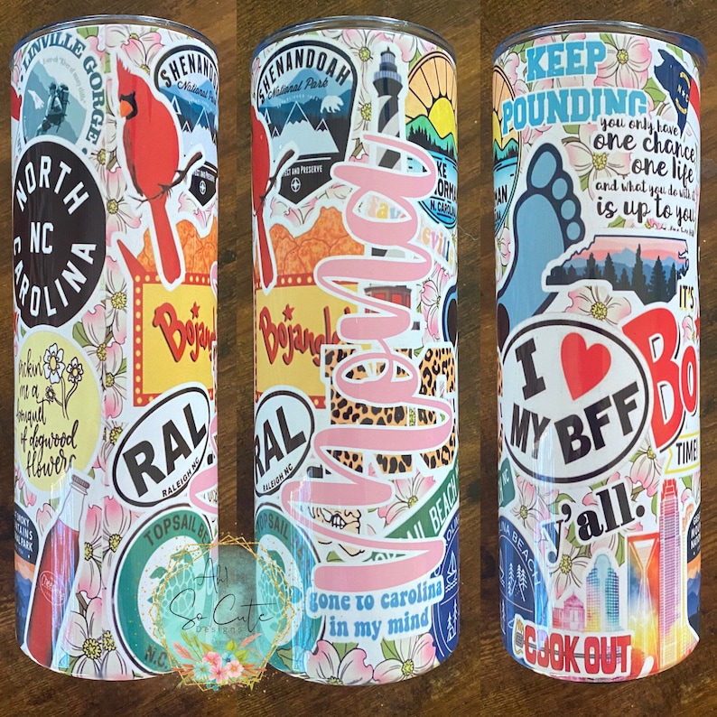 May include: A white tumbler with a variety of colorful stickers, including a red cardinal, a lighthouse, a North Carolina outline, and the text "Bojangles" and "gone to Carolina in my mind".