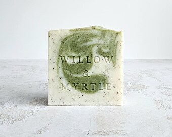 May include: A bar of soap with a green and white swirl pattern. The soap is labeled "Willow & Myrtle".