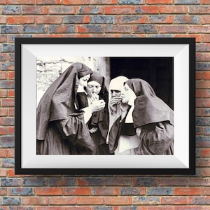 May include: Black and white photograph of four nuns in habits, standing together and smoking cigarettes. The nuns are looking at the camera.