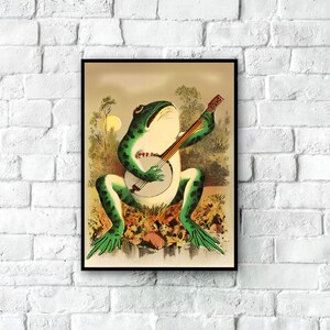 May include: A vintage illustration of a green frog playing a banjo. The frog is sitting on a rock with green foliage behind it. The banjo is brown with a white body and black strings.
