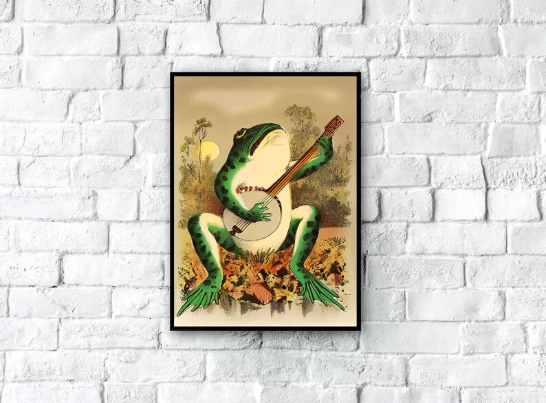 May include: A vintage illustration of a green frog playing a banjo. The frog is sitting on a rock with green foliage behind it. The banjo is brown with a white body and black strings.