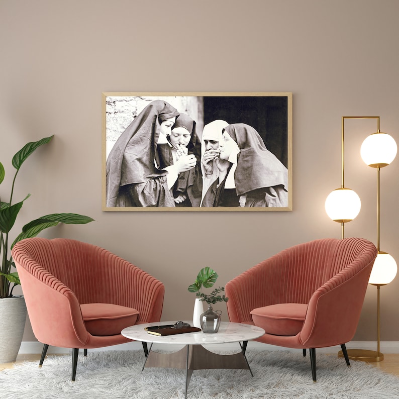 May include: Black and white photograph of four people wearing traditional clothing, possibly nuns, standing together and looking at the camera. The image is framed in a wooden frame.