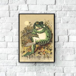 May include: A vintage illustration of a green frog playing a flute in a marshland setting. The frog is sitting on a log and has a large, round eye. The illustration is in a black frame.