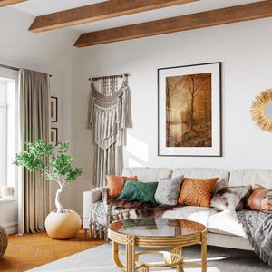 May include: A living room with a white couch, a wooden coffee table, and a woven wall hanging. The room has a bohemian style with natural textures and colors.