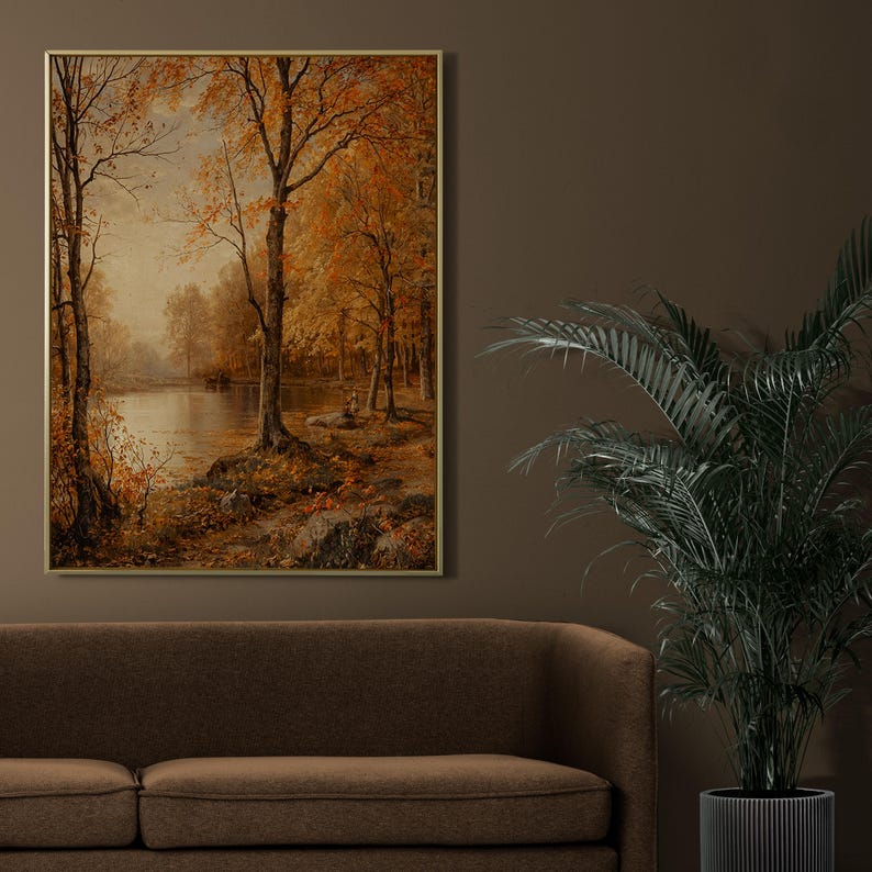 May include: A framed painting of a forest scene with a lake in the foreground. The trees are in autumn colors of orange, yellow, and red. The lake is calm and reflects the trees.