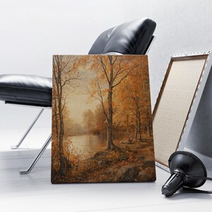 May include: A painting of a forest scene with a lake in the background. The trees are mostly brown and yellow, and the lake is a light blue. The painting is framed in a simple wooden frame.