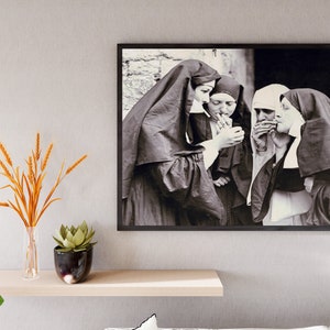 May include: Black and white photograph of four nuns in habits, standing together and smoking cigarettes.