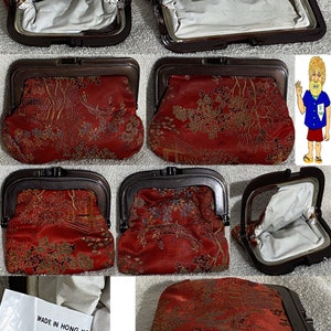 May include: A red coin purse with a gold floral pattern and a metal frame. The purse is open and the inside is lined with white fabric. The purse has a label that reads "MADE IN HONG KONG".