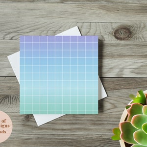 May include: A light blue to green gradient grid pattern on a white note pad. The note pad is on a wood surface. The text "Kween of Artz Designs Note Pads" is on a pink circle.