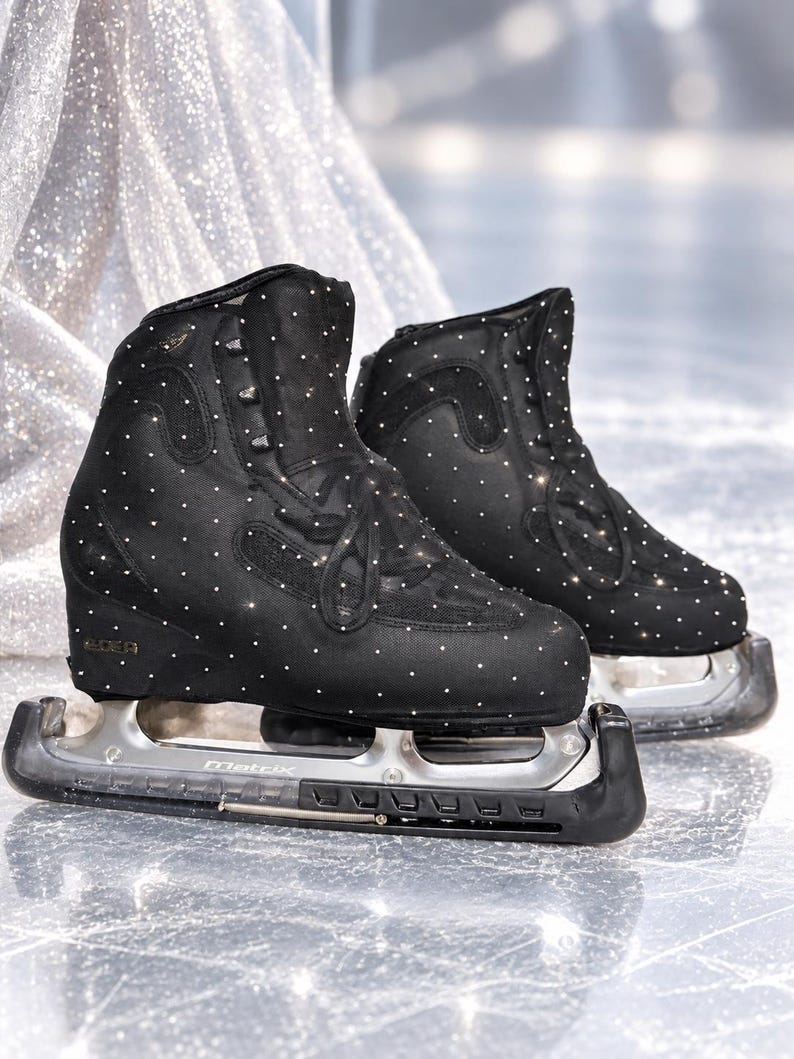 May include: A pair of black ice skates featuring a high-top boot design covered in small, reflective white dots. The skates have black laces, a structured ankle support, and silver-toned metal blades with the word Matrix engraved on the side.
