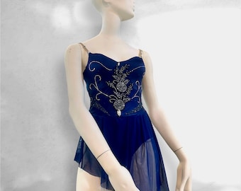 May include: A dark blue leotard featuring a sweetheart neckline, thin shoulder straps, and a sheer asymmetrical skirt. The bodice is decorated with intricate black beadwork and clear crystal accents arranged in a floral-inspired pattern.