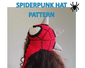 Puede incluir: Un gorro de crochet rojo y negro con un diseño de telaraña y un ojo blanco. El gorro tiene tres cuernos blancos en la parte superior y una larga bufanda negra.