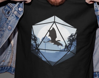 May include: A black t-shirt with a graphic of a blue and white dice with a silhouette of a dragon flying in front of a full moon.