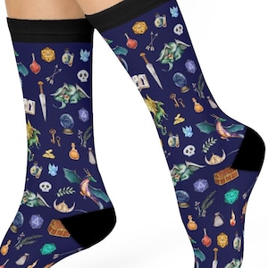 May include: A pair of blue socks with a colorful pattern of dragons, dice, keys, potions, and other fantasy-themed imagery.
