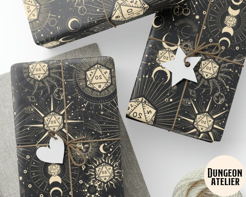 May include: Black and gold wrapping paper with a celestial theme featuring dice, moons, and stars. The text "DUNGEON ATELIER" is printed in the bottom right corner.