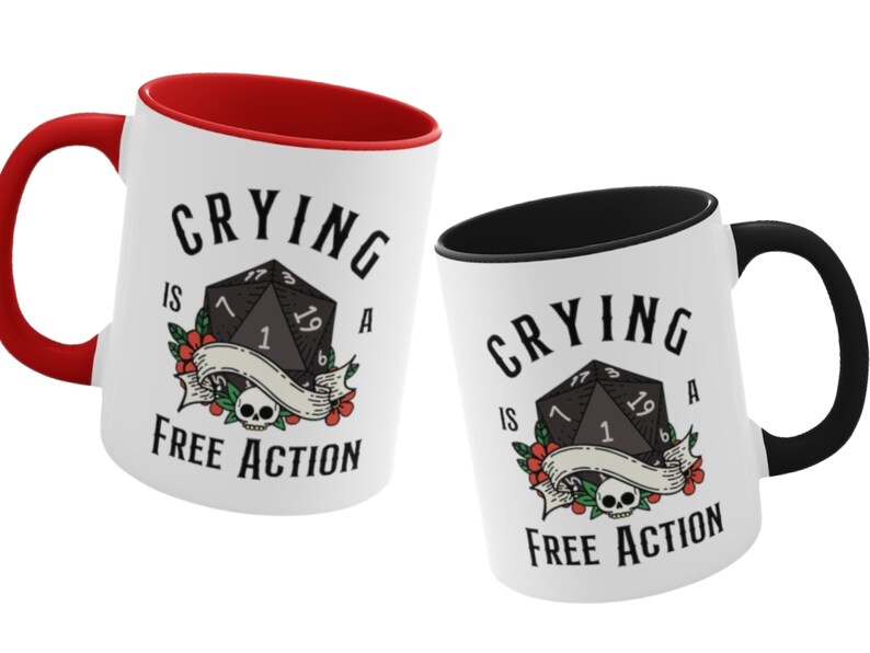 May include: Two white ceramic mugs with black and red accents. Both mugs feature a black and white illustration of a twenty-sided die with the text "Crying is a Free Action".