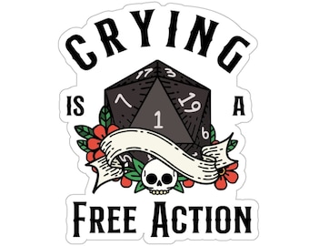 May include: A black and white sticker featuring a black 20-sided die, red and green flowers, a skull, and the text "Crying is a free action".