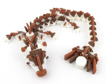 May include: A 3D-printed articulated dragon figurine in white, brown, and chocolate colors. The dragon has a detailed design with a segmented body, legs, and head. The figurine is posed on a white surface.