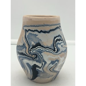 May include: A hand-painted ceramic vase with a marbled design in shades of blue, black, and white.