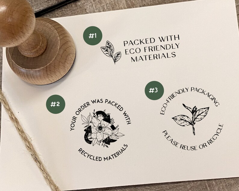 May include: Three round rubber stamps with black ink. The first stamp says "Packed with Eco Friendly Materials" and has a small leaf design. The second stamp says "Your order was packed with recycled materials" and has a floral design. The third stamp says "Eco-friendly packaging please reuse or recycle" and has a small leaf design.