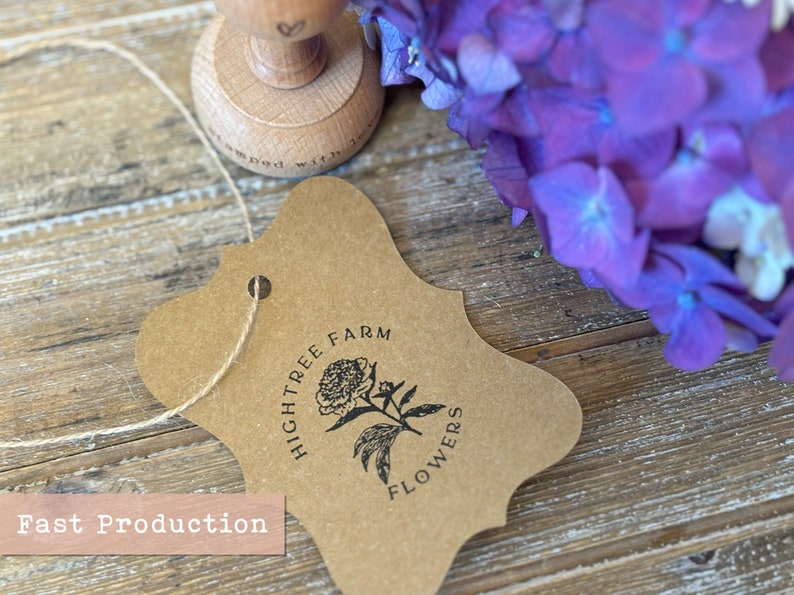 Custom product tag stamped with floral logo design on kraft paper, perfect for small business branding, packaging, or personalized hang tags.