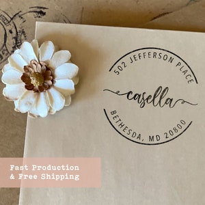 May include: A brown paper envelope with a black and white round return address stamp. The stamp says "502 Jefferson Place, casella, Bethesda, MD 20800". The envelope also has a white daisy flower with a brown center.