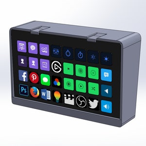 May include: A gray, rectangular control panel with a black screen displaying various app icons. The icons include social media, video editing, and streaming platforms. The panel has a sleek, modern design.