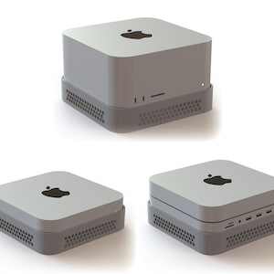 May include: A light gray desktop computer with a dark gray base. The computer has a square shape with rounded corners and a black Apple logo on top. The base has a perforated design.