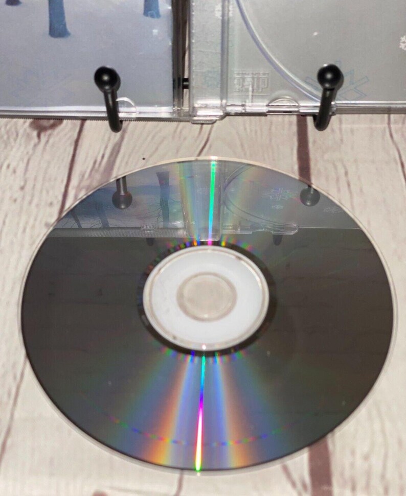 May include: A silver compact disc with a rainbow iridescent effect. The disc is blank and has a small central hole.