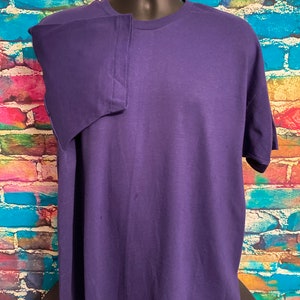 May include: A solid purple t-shirt with short sleeves and a crew neck.
