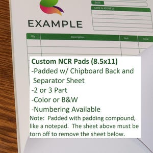 May include: A white invoice pad with the word "EXAMPLE" and a colorful logo. The pad includes details for custom NCR pads, 8.5x11 inches, with chipboard backing, separator sheets, and available in color or black and white.