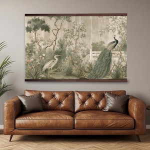 May include: A rectangular wall hanging featuring a printed landscape scene with a white heron and a peacock perched on a fence. The artwork is framed by dark wooden bars at the top and bottom, displaying muted green, brown, and cream tones.
