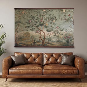 May include: A large rectangular wall hanging featuring a printed landscape scene with trees, blooming flowers, and foliage in muted green, brown, and pink tones, secured between two dark wooden horizontal bars at the top and bottom.
