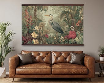 May include: A rectangular wall hanging featuring a detailed illustration of a grey heron standing amidst a lush tropical landscape with vibrant red, yellow, and pink flowers, green foliage, and palm trees, framed by dark wooden bars at the top and bottom.