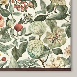 Vintage floral tapestry featuring detailed illustrations of various flowers and green leaves, printed on light canvas-textured fabric, with walnut-colored wooden hangers on top and bottom.