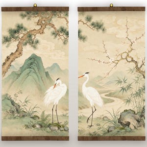 May include: A pair of vertical wall scrolls featuring a continuous landscape painting. The artwork depicts white cranes, green mountains, pine trees, and bamboo stalks in a soft, muted color palette with a light beige background.