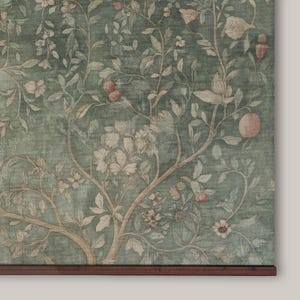 May include: A botanical print featuring a detailed illustration of a tree with branches, leaves, flowers, and fruit. The color palette includes shades of green, beige, and touches of pink. The artwork is mounted on a wooden frame.