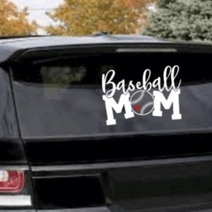 May include: White vinyl decal with the text "Baseball Mom" and a baseball with a red heart in the centre. The decal is on the back window of a black SUV.