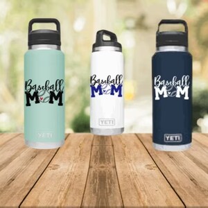 May include: Three stainless steel water bottles with black lids and handles. Each bottle has a different colour: light blue, white, and navy blue. The bottles have a baseball and the text "Baseball Mom" printed on them.