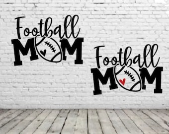 May include: Black and white graphic design with the text "Football Mom" and a football with a red heart.