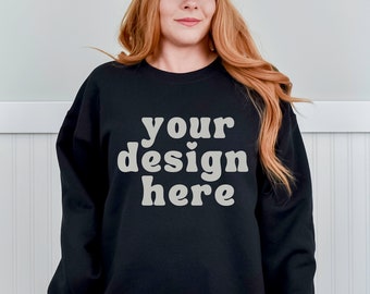 May include: A black sweatshirt with the text "your design here" in a retro font.