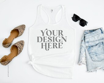 May include: White racerback tank top with the text "YOUR DESIGN HERE" printed in gray on the front. The tank top is styled with denim shorts, sunglasses, and leopard print flats.